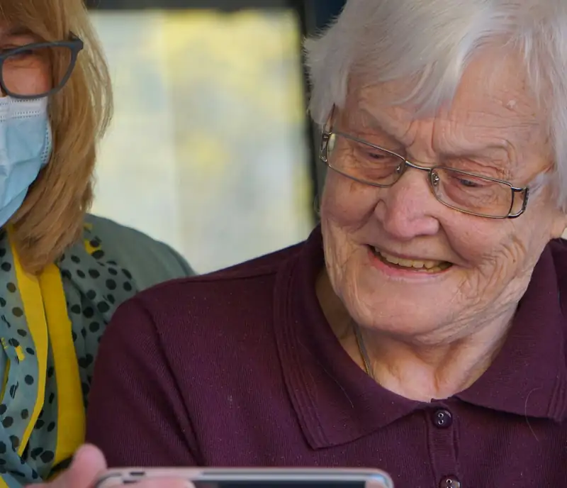 Smiling senior woman being cared for warmly