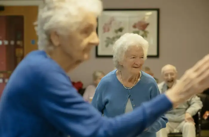 Senior couple engaging with fellow residents in an independent living community activity